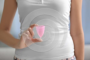 Close up view of young woman with menstrual cup