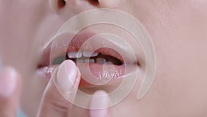 Close up view of young woman touching her lips . with light nude make up.