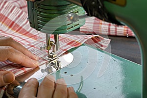 Close-up of a vintage 50s sewing machine and a female hand.