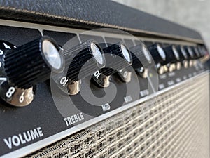 Close-up vintage amplifier combo with black knob and control panel. clean and low-gain distortion.