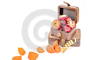 Close up of vintage boxes with orange flowers  on white background.