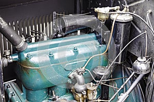 Close-up of a vintage car engine under an open hood. photo