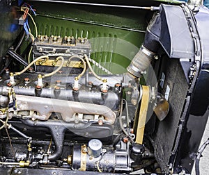 Close-up of a vintage car engine under an open hood. photo