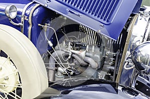 Close-up of a vintage car engine under an open hood. photo