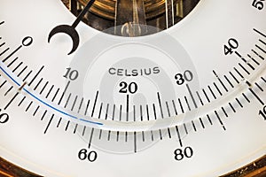 Close up of a vintage circular thermometer