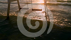 Close up Vintage empty air swing at ocean during sunset surf. Relax 4k footage