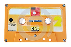 Close up vintage and old yellow audio cassette tape isolated on a white background