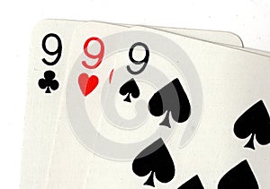 Close up of vintage playing cards showing three nines. photo