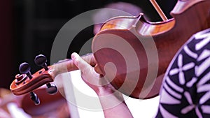 Close-up of a violin and a hand on the instrument's neck.Symphony Orchestra.Violinists' performance.