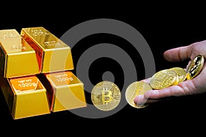 Close-up virtual currency bitcoin and golden bullions isolated on black background