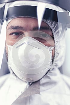 Close up of virus scientist wearing ppe equipment in microbiology laboratory photo