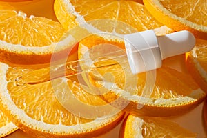 A close-up of a Vitamin C serum in a droplet, surrounded by fresh, vibrant orange slices. mockup