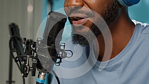 Close up of vlogger using microphone for online podcast