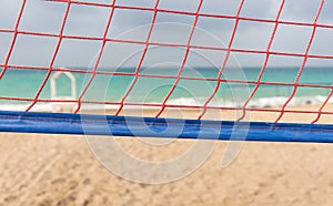 Close up on a volley ball net on a sandy beach