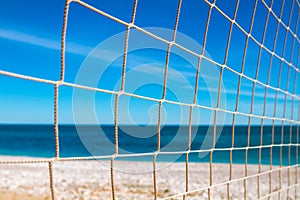 Close up of volleyball net on a beach.