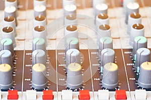 Close up Volume adjusting knobs on audio mixer controller in control room