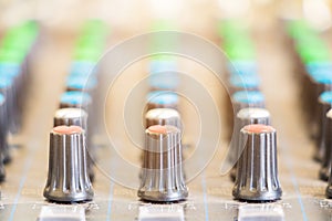 Close up Volume adjusting knobs old on audio mixer controller in control room