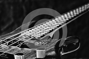 Close-up volume control of bass guitar. Black and white toning