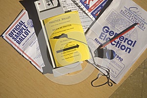 Close-up of a voting booth with ballots, ballot machine and election pamphlets, CA