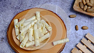 Close up, wafer roll stick on a wooden bowl. High angle view, Newyear Concept