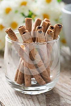 Close up, Wafer roll sticks cream rolls in a cup.