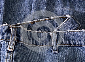 Close up of waist of old faded jeans