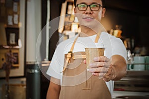 Close-up of a waitress serving a cup of coffee. Selective focus.