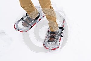 Close-up, walking in the snow in special devices, snowshoes, for better maneuverability