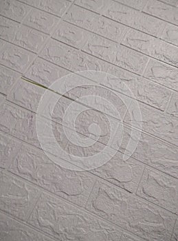 Close-up of a wall covered with a plastic film. White ceramic tile wall texture background.