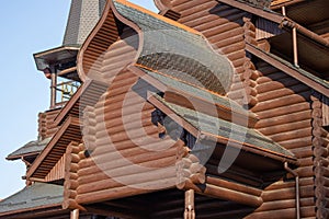 Close-up of the wall, roof and log joints of an old wooden log christian orthodox church