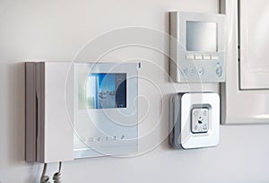 Close up wall with security alarm and video intercom