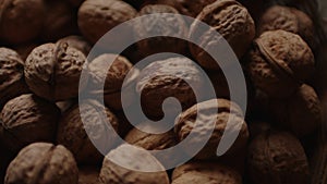Close up of walnuts crop. Texture of pile of nuts in shell.