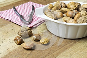 close up of walnuts, hazelnuts and almonds on wooden table