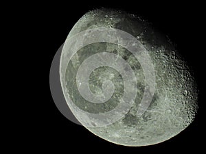 close-up of the waning three-quarter moon in the starry night sky