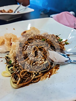 Close up of the wantan noodle with fried bean curd and sesame photo