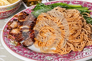 Close-up of wanton noodle with barbecue pork, vegetable and dumpling, popular Chinese food