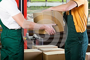 Close-up of warehouse workers with box