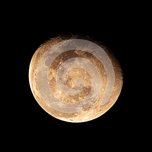 Close up of warning gibbous moon phase from earth