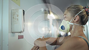 Close up washing hands with an automatic alcohol antibacterial sanitiser dispenser machine at airport. Woman with