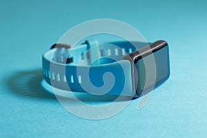 Close up of a watch with a blue strap