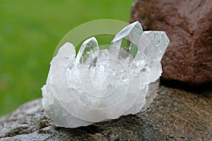 Quartz crystal cluster on a rock photo