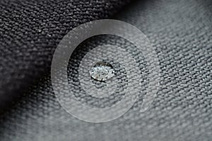 Close up water drop on grey gunny textile. Concept for easy clean, waterproof surfaces