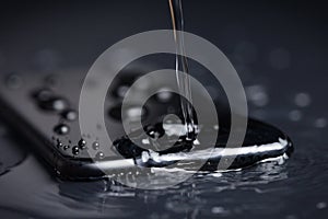 Close-up water drop on phone device waterproof concept
