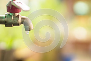 Close up water drop from tab, leaking water, save water and water conservation concept