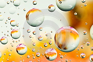 Close-up on water drops background on orange and white surface.