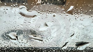 Close-up water drops on glass. Macro raindrops on window of car. Wet weather. Rain season. Soft focus. film grain pixel