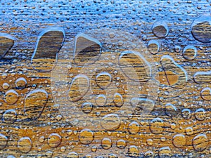 Close-up water drops on a wooden surface