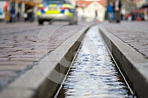 Close-up on water-filled runnel in the street