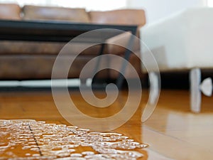 Close up of water flooding on living room parquet floor in a house - damage caused by water leakage photo