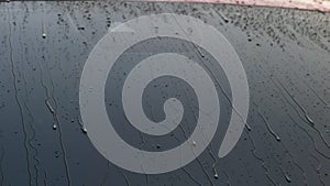 Close-up of water flowing on a car while a worker is using a high-pressure washer to wash the car. car wash service concept.